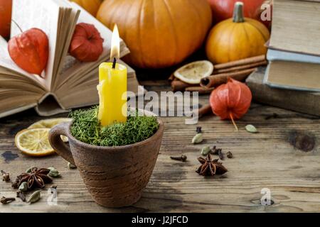 Autumn decorations: candle holder in old ceramic jug. Retro style Stock Photo