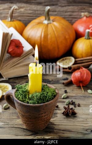 Autumn decorations: candle holder in old ceramic jug. Retro style Stock Photo
