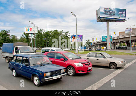 Moscow, Russia - July 24, 2012: Car stop at a crossroads in the cosmonaut museum district, northeast of the city. Models of cars, new and old compared Stock Photo