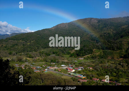 A rainbow passes over the mountains in Copey in Costa Rica's Los Santos coffee region. Stock Photo