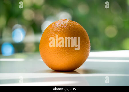 The organic orange isolated on green blurred background Stock Photo