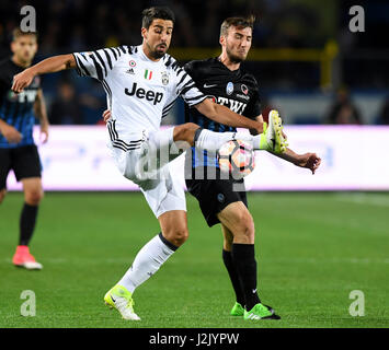 Bergamo. 29th Apr, 2017. Juventus's Sami Khedira (L) vies with Atalanta's Bryan Cristante during a Serie A soccer match between Juventus and Atalanta at 'Atleti Azzurri D'Italia' stadium in Bergamo, Italy, April. 28, 2017. The match ended with a 2-2 draw. Credit: Alberto Lingria/Xinhua/Alamy Live News Stock Photo