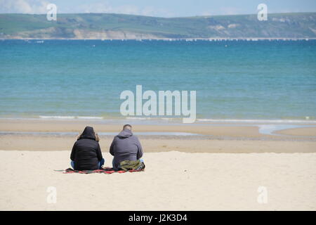 Weymouth, Dorset, UK. 29th Apr, 2017. Beach goers make the best or a cool and breezy day with occasional spells of sunshine at Weymouth as the weather is set to deteriorate tomorrow with rain moving into the area. Credit: Tom Corban/Alamy Live News Stock Photo