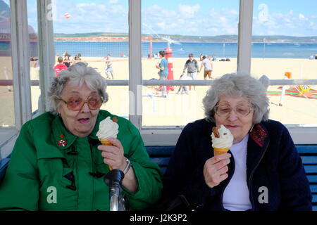 Weymouth, Dorset, UK. 29th Apr, 2017. Two Weymouth resisents enjoy an icecream by the beach and make the best or a cool and breezy day with occasional spells of sunshine at Weymouth as the weather is set to deteriorate tomorrow with rain moving into the area. Credit: Tom Corban/Alamy Live News Stock Photo