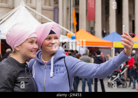 Trafalgar Square, London, UK. 29th April, 2017. Two young women from The Czech Republic have learned how to tie a turban at the Vaisakhi festival in Trafalgar Square today. Credit: Tove Larsen/Alamy Live News Stock Photo