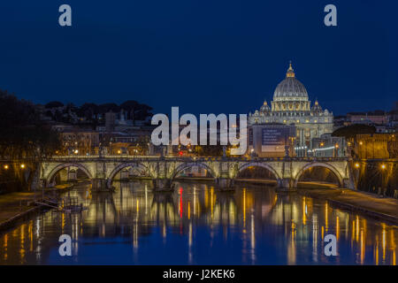 Basilica di San Pietro and the Vatican in Rome, Italy, viewed from the Ponte Sant'Angelo across the River Tiber and Ponte Vittorio Emanuele II at dawn Stock Photo