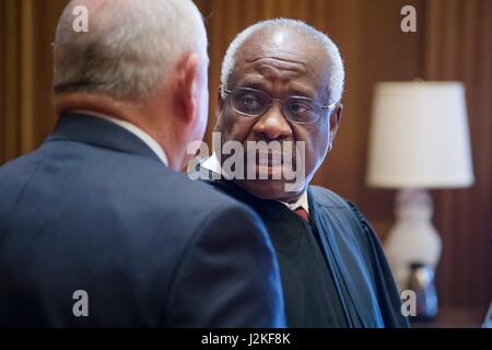 Former Georgia Gov. Sonny Perdue, left, chats with Supreme Court Clarence Thomas following his swearing in ceremony as the 31st U.S. Secretary of Agriculture at the Supreme Court April 25, 2017 in Washington, DC. Stock Photo