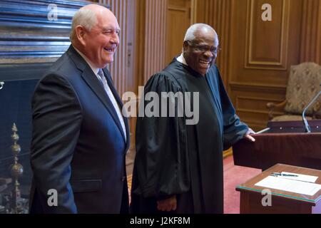 Former Georgia Gov. Sonny Perdue, left, shares a laugh with Supreme Court Clarence Thomas following his swearing in ceremony as the 31st U.S. Secretary of Agriculture at the Supreme Court April 25, 2017 in Washington, DC. Stock Photo