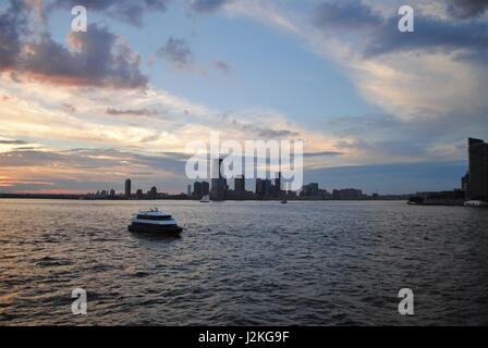 A yacht passing by Lower Manhattan in the Upper Bay, New York, the United States Stock Photo