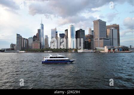 A yacht passing by Lower Manhattan in the Upper Bay, New York, the United States Stock Photo