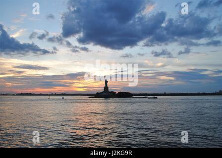 Statue of Liberty with a dramatic sunset behind, New York best travel destination, the United States Stock Photo
