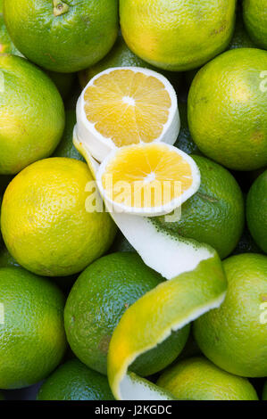 Fresh Brazilian limes (limão) cut open with a decorative flourish at an outdoor fruit and vegetable farmers market in Rio de Janeiro, Brazil Stock Photo
