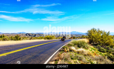 A beautiful scenic drive along the Bartlett Dam Road in the open space with green foliage and the mountains on the horizon in Tonto National Park, AZ Stock Photo