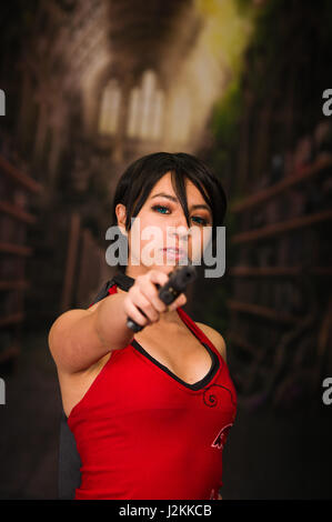 Powerful Woman Holding Gun Action Movie Style resident evil cosplay costume Stock Photo