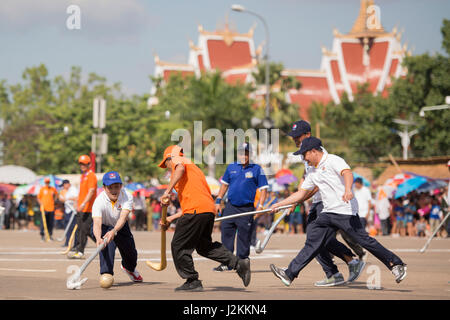 a Game of the traditional Hockey Tikhy or Lao Hockey at a ceremony at the Pha That Luang Festival in the city of vientiane in Laos in the southeastasi Stock Photo