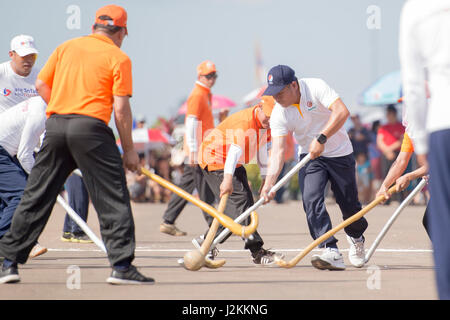 a Game of the traditional Hockey Tikhy or Lao Hockey at a ceremony at the Pha That Luang Festival in the city of vientiane in Laos in the southeastasi Stock Photo