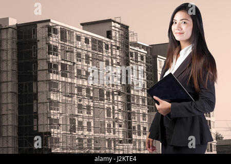 building, developing, construction and architecture concept - smiling woman Stock Photo
