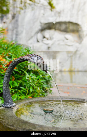 Water fountain near memorial of dying lion in Lucerne, Switzerland Stock Photo