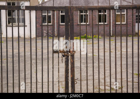 Set of locked security gates at a derelict or abandoned industrial or commercial premises Stock Photo