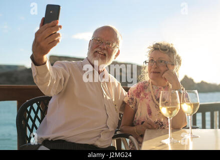 Old couple taking a selfie outside Stock Photo