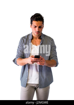 Handsome young man typing on cell phone, worried Stock Photo