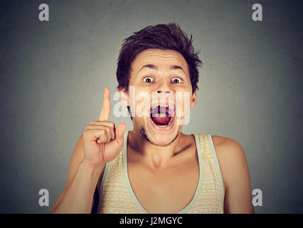 Headshot man having good idea aha thought pointing index finger up solution found isolated on grey background. Human face expression emotion body lang Stock Photo