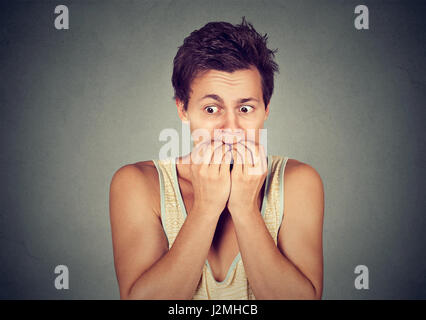 Portrait anxious young man biting his nails fingers freaking out Stock Photo