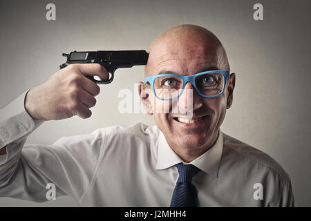 businessman holding gun to his head Stock Photo