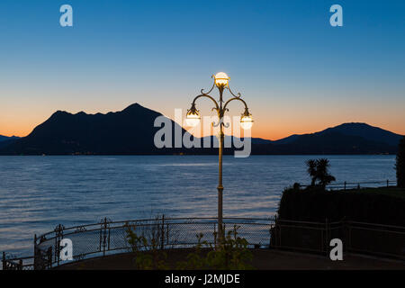 Ornate lamppost on lakeside promenade with stunning views at dawn at Stresa, Lake Maggiore Italy in April Stock Photo