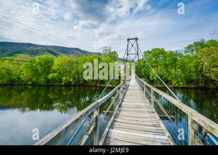 Swinging pedestrian bridge over the James River in Buchanan, Virginia. Stock Photo