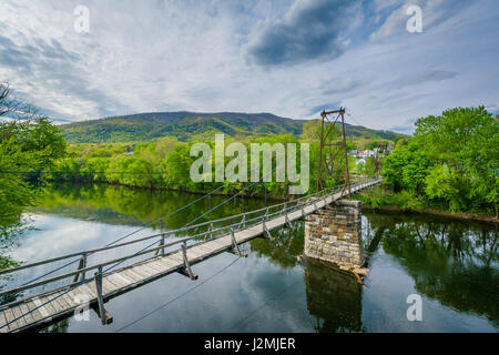 Swinging pedestrian bridge over the James River in Buchanan, Virginia. Stock Photo