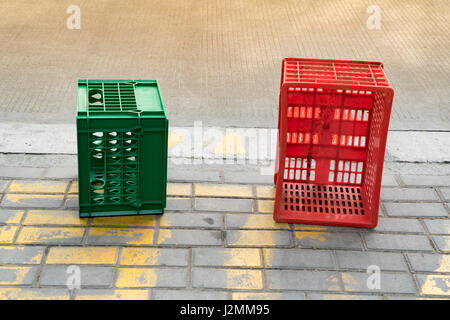 used red and green plastic box beside the road Stock Photo