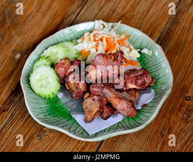 Fried sparerib on the wooden background . Stock Photo