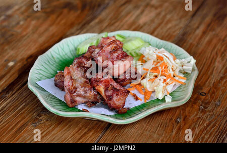 Fried sparerib on the wooden background . Stock Photo