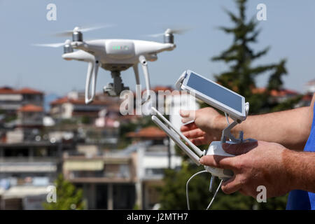 Controlling a remote helicopter drone. Drone flight remote controller in man hands Stock Photo