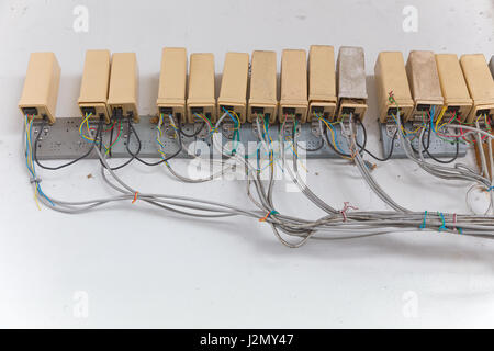 Old cluster of telephone connection boxes on wall Stock Photo