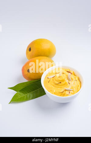 hapus or alphonso Mango pudding / Mango shrikhand or srikhand or amrakhand - Mango dessert with condensed milk magoes and nuts, selective focus over w Stock Photo