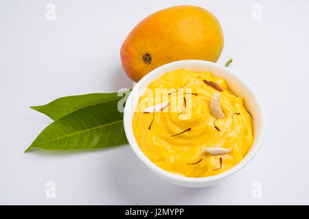 hapus or alphonso Mango pudding / Mango shrikhand or srikhand or amrakhand - Mango dessert with condensed milk magoes and nuts, selective focus over w Stock Photo