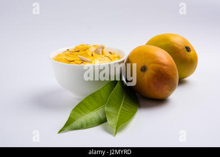 hapus or alphonso Mango pudding / Mango shrikhand or srikhand or amrakhand - Mango dessert with condensed milk magoes and nuts, selective focus over w Stock Photo