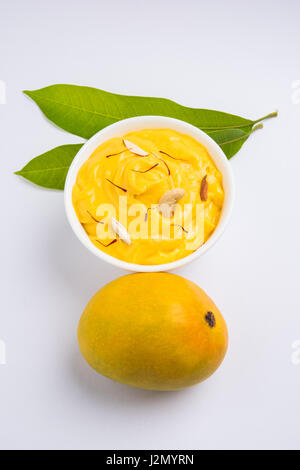 hapus or alphonso Mango pudding / Mango shrikhand or srikhand or amrakhand - Mango dessert with condensed milk magoes and nuts, selective focus over w Stock Photo