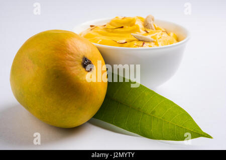 hapus or alphonso Mango pudding / Mango shrikhand or srikhand or amrakhand - Mango dessert with condensed milk magoes and nuts, selective focus over w Stock Photo