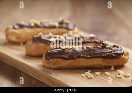 traditional french eclairs with chocolate and hazelnuts, shallow focus Stock Photo