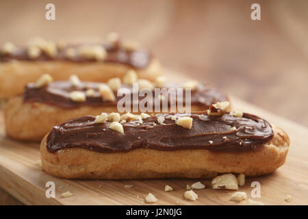 traditional french eclairs with chocolate and hazelnuts, shallow focus Stock Photo