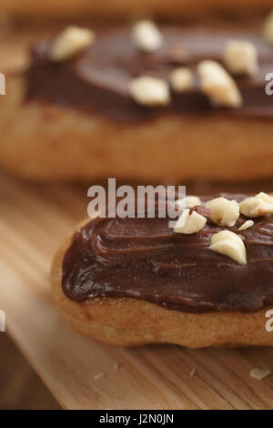 traditional french eclairs with chocolate and hazelnuts, shallow focus Stock Photo