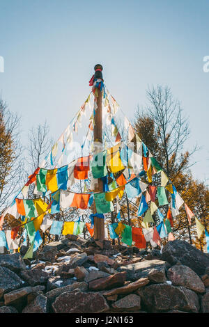 colourful obo and aobao landscape in mongolia ,mongol totem, in forest with blue sky,veritcal Stock Photo