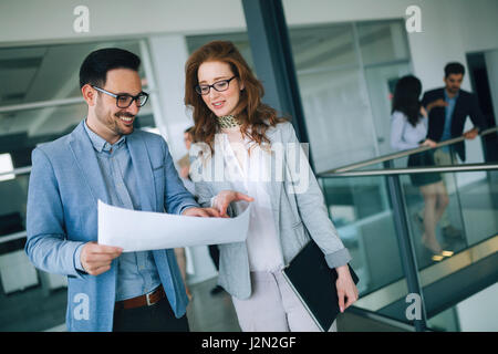 Professionals business colleagues collaborating and discussing project plans Stock Photo