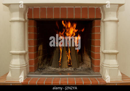 Burning fireplace. Fireplace as a piece of furniture macro Stock Photo