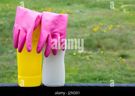 Spring cleaning concept with supplies over floral background macro