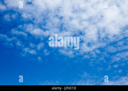 pretty clouds and a sun flare on a sunny day with blue sky toned with a retro vintage instagram filter photo Stock Photo