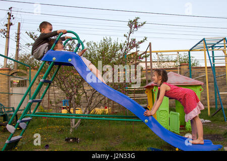 Children are playing at the playground outdoors Stock Photo